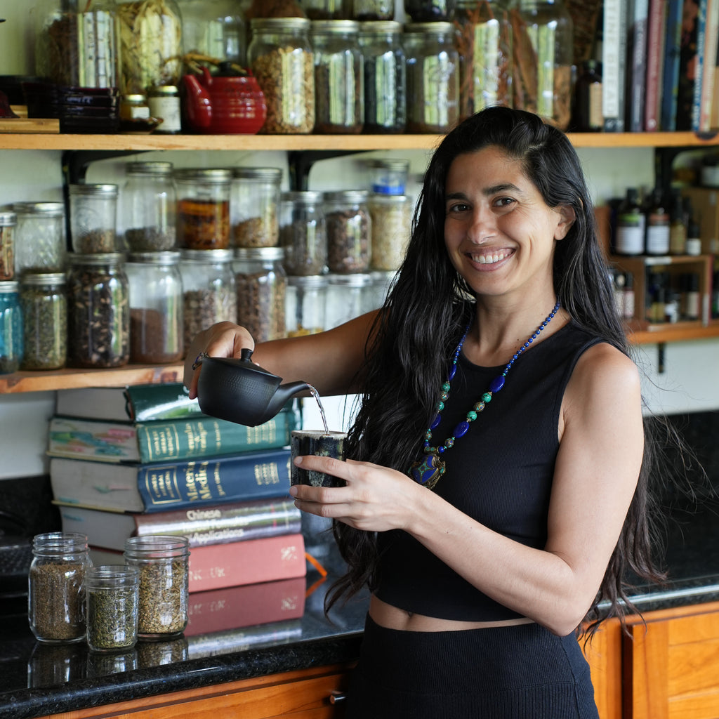 Herbalist pouring tea